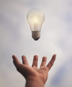 lightbulb above outstretched palm of hand